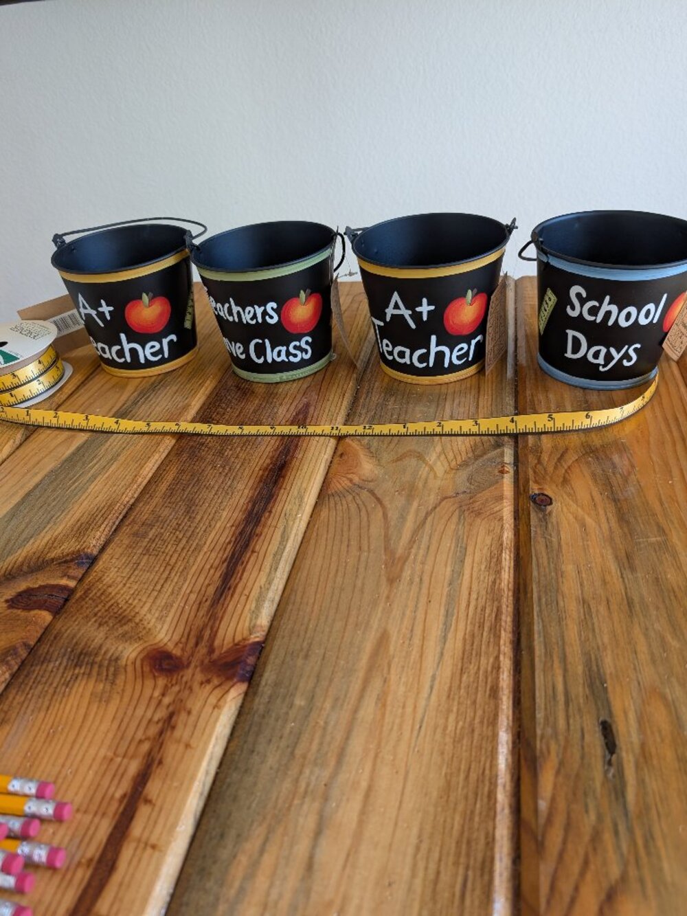 Four hand painted reached pales with ribbon